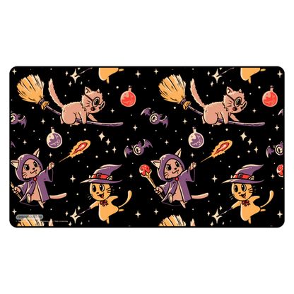 Halloween-themed playmat with cats in witch costumes casting spells and riding broomsticks on a black background